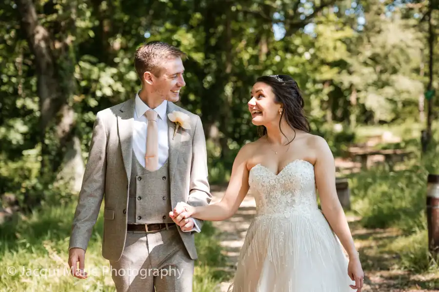 Bride and Groom walking in dappled sunlight at the Solent Hotel, Hampshire by Hampshire Wedding Photographer Jacqui Marie Photography 